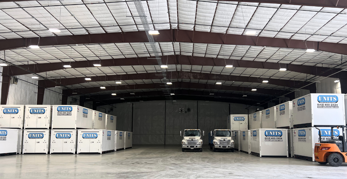 UNITS of Austin's portable storage facility with containers stacked, and two delivery trucks.