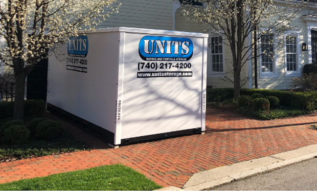 Units of Northwest Dallas Fort Worth portable storage unit sitting on the driveway of a suburban home