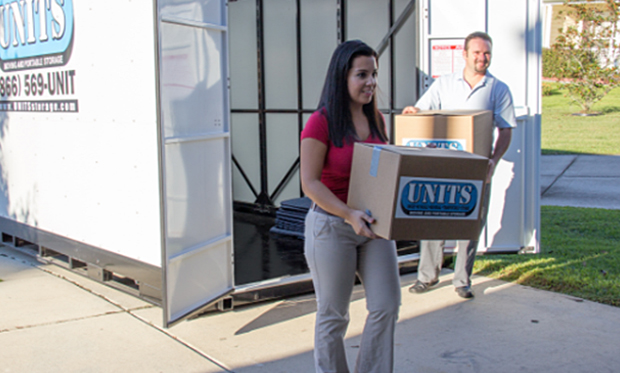 Women opening a Units moving and portable storage container in her driveway