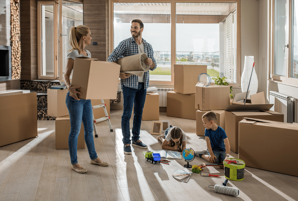 A family unpacking items from boxes in their new house.