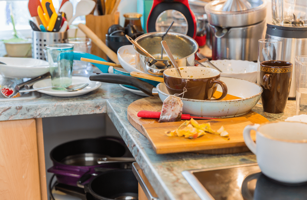 Dirty dishes completely fill sink and surrounding countertop.