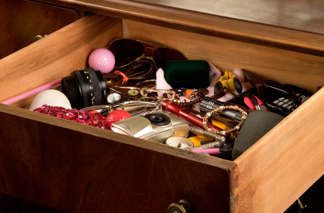 Drawer filled with clutter.