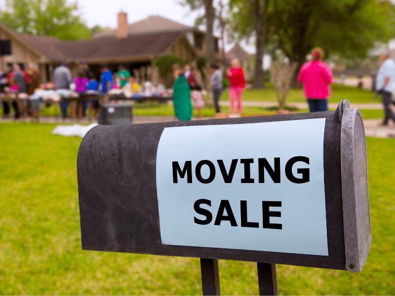 Moving sale sign on a mailbox.