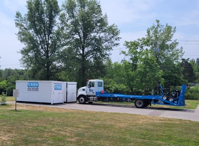 UNITS Moving and Portable Storage of Cincinnati containers sitting in a driveway with a UNITS truck behind them.