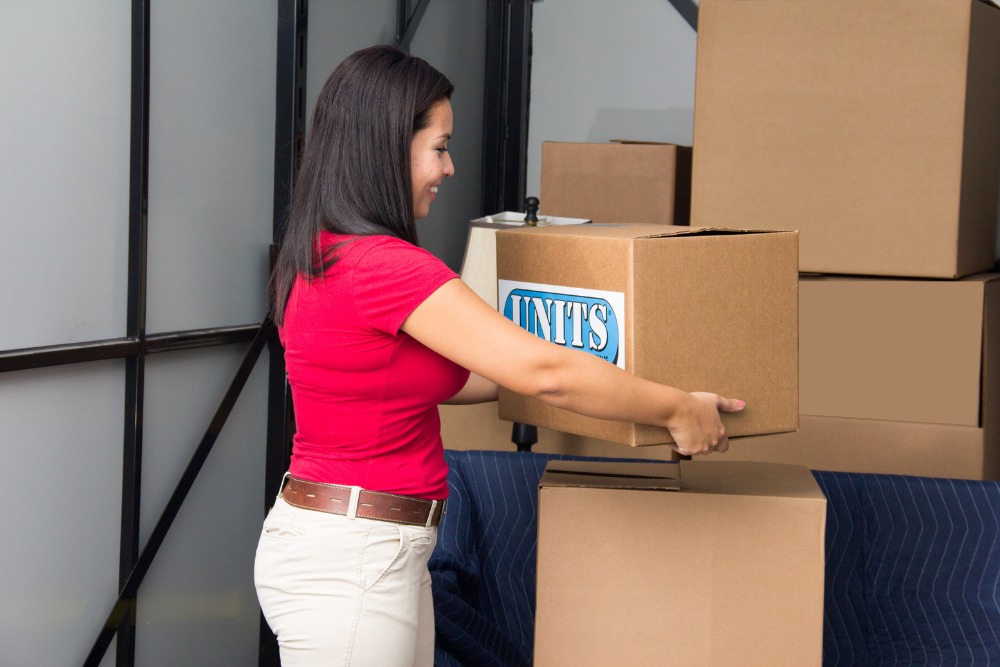 Woman moving cardboard boxes into her UNITS Moving and Portable Storage container.