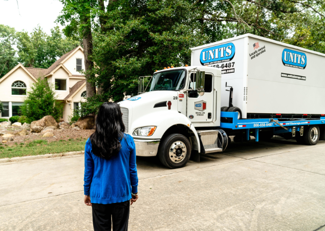 UNITS of Detroit portable storage delivery truck and a woman waiting for delivery.