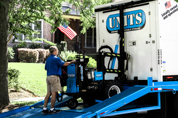 Man using a ROBO-UNIT to move a UNITS Moving and Portable Storage container.