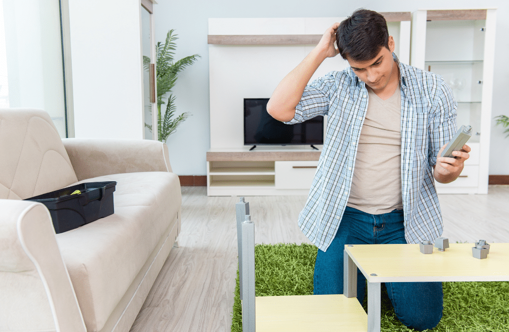 Man looking confused putting together a coffee table.