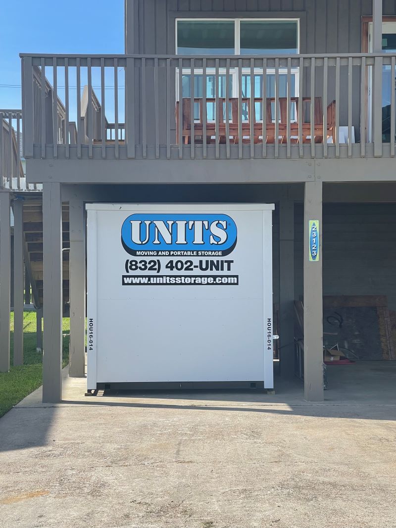 A Units of Houston Gulf Coast container sitting under a porch.