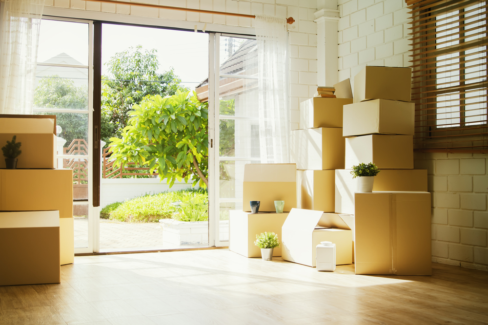 Cardboard boxes stacked in the corner of a room.