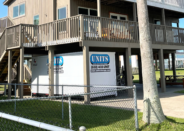 A Units of Houston Gulf Coast container sitting under a porch.