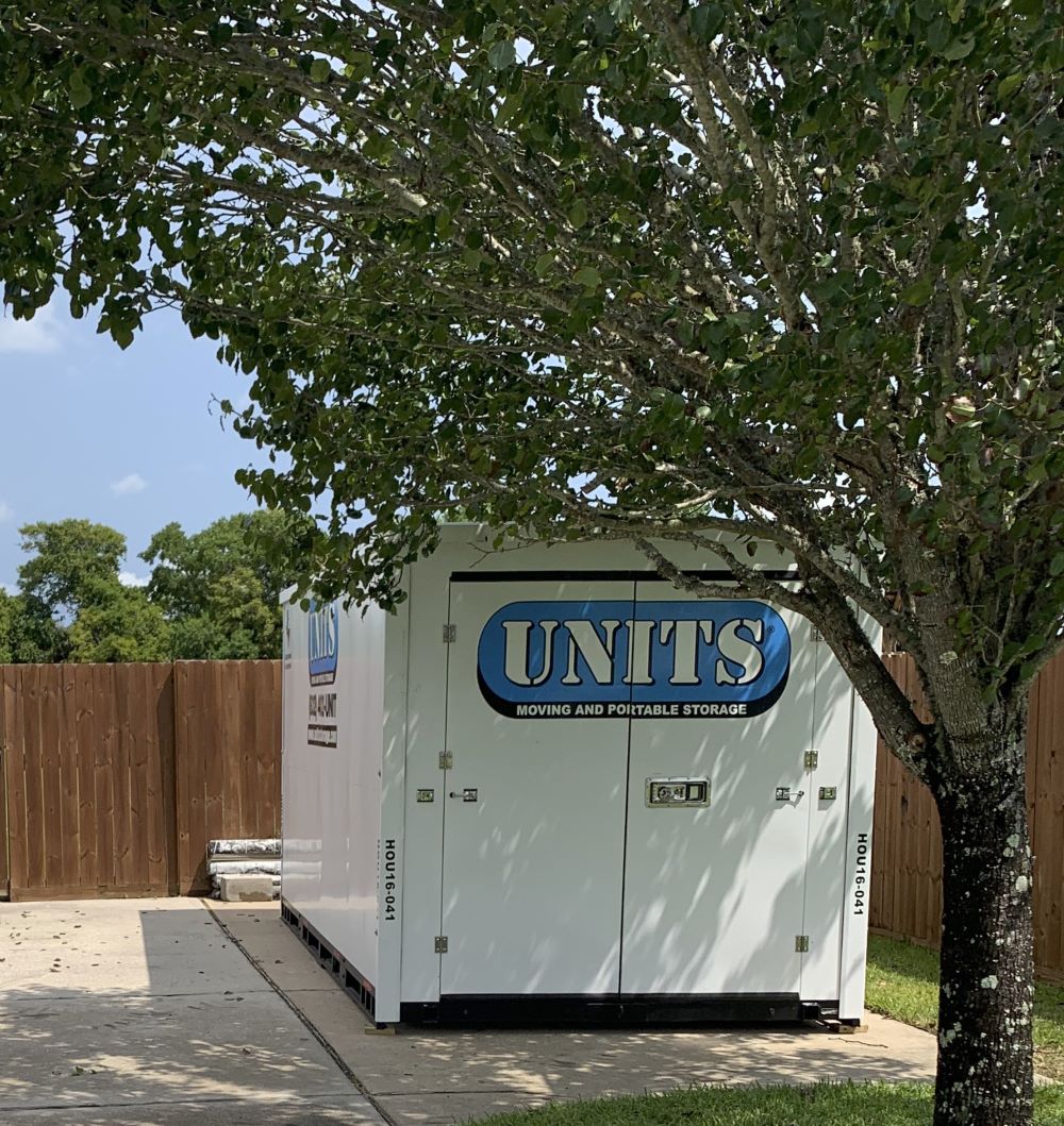 A Units of Houston Gulf Coast container sitting in a driveway.