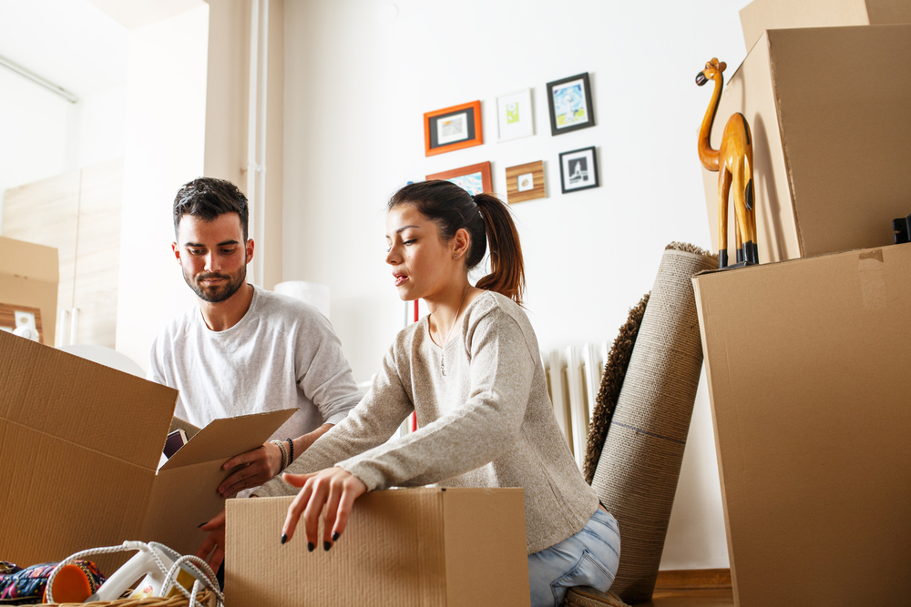 Couple packing cardboard boxes.