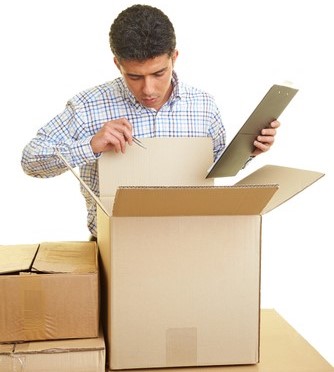 Man looking in a cardboard box.