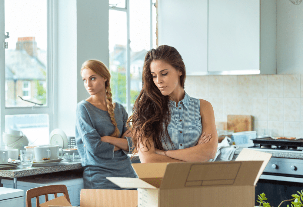 Two women in a kitchen frustrated with each other.