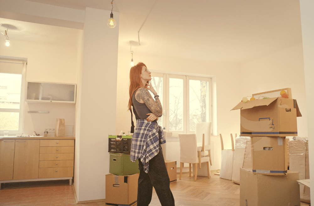 Woman standing in a mostly packed kitchen.