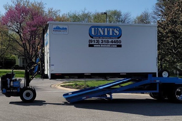 A Units of Kansas City container getting loaded onto a truck.