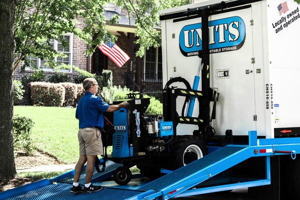 A Units Of Lexington Kentucky container getting loaded on a truck.