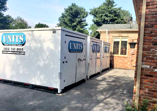 Three Units Of Lexington Kentucky containers sitting in a driveway.