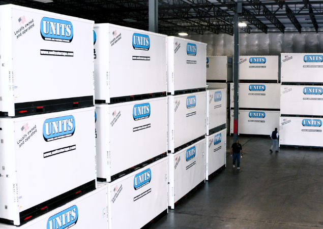 Units Of Lexington Kentucky containers stacked in a warehouse.