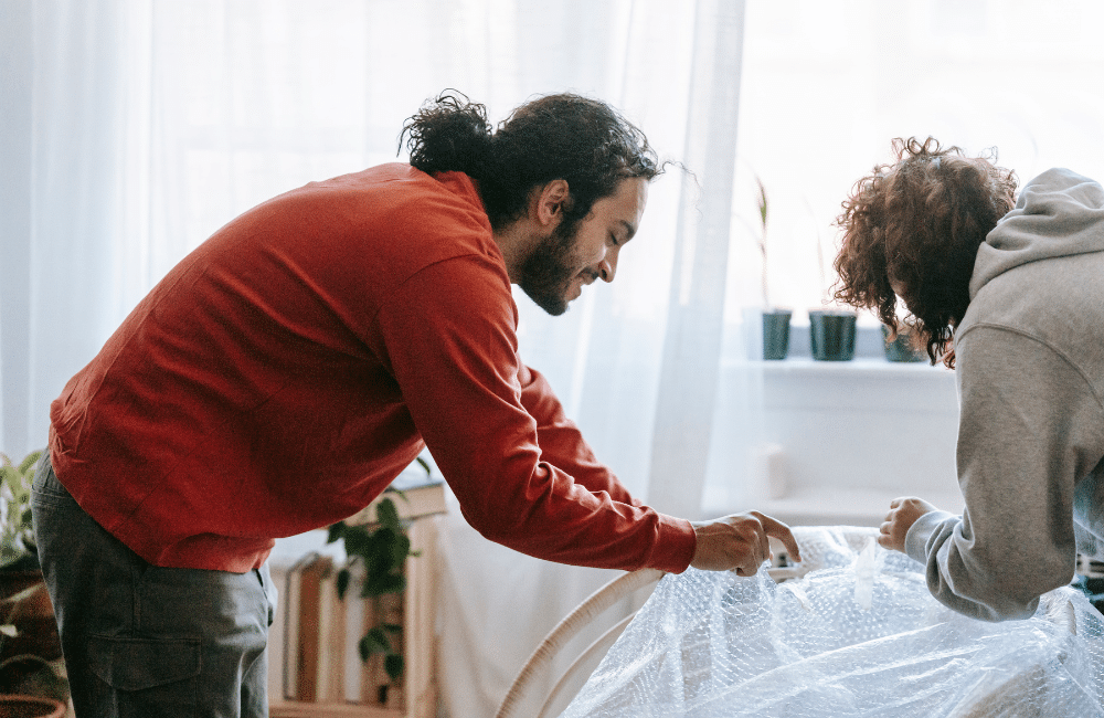 Couple preparing their belongings for a bad weather move.