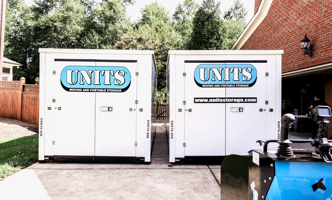 Two Units Of Louisville containers sitting in a driveway.