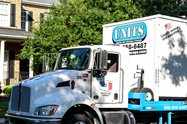 A Units Of Louisville truck parked in front of a house.