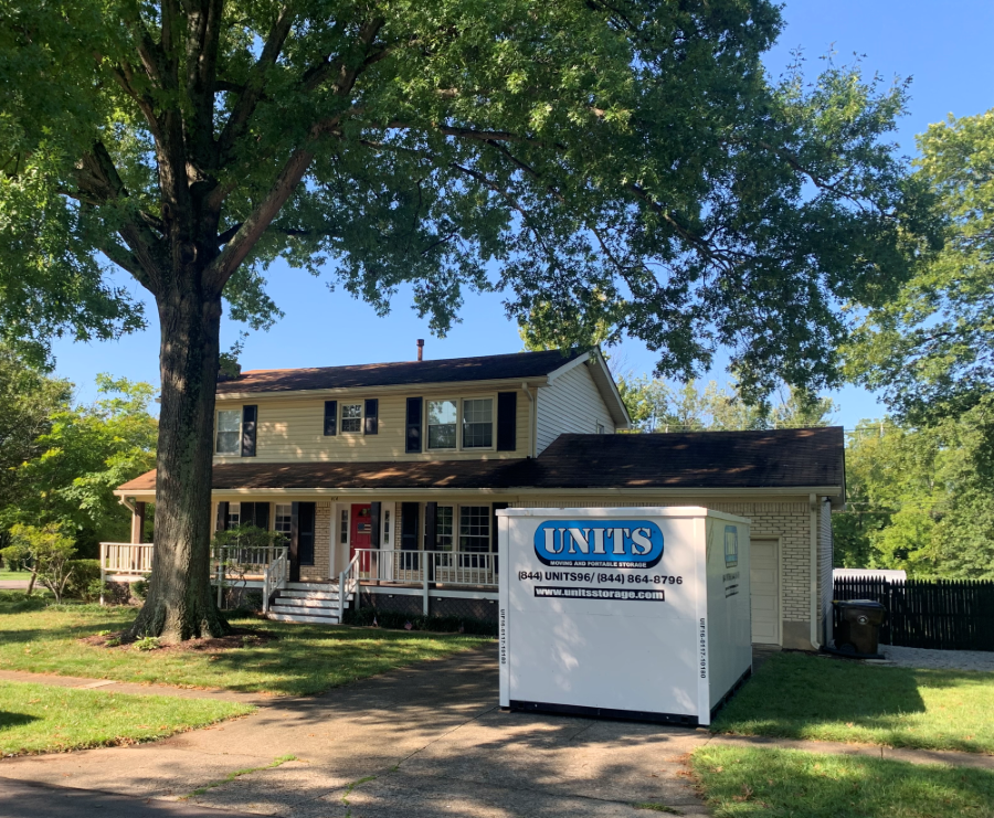 A Units Of Louisville container sitting in a driveway.