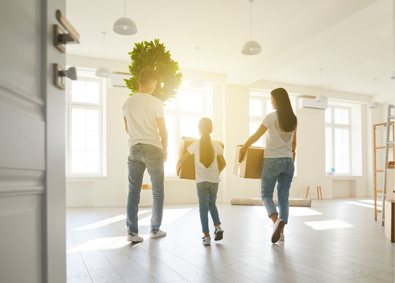 A family moving cardboard boxes into their new home.