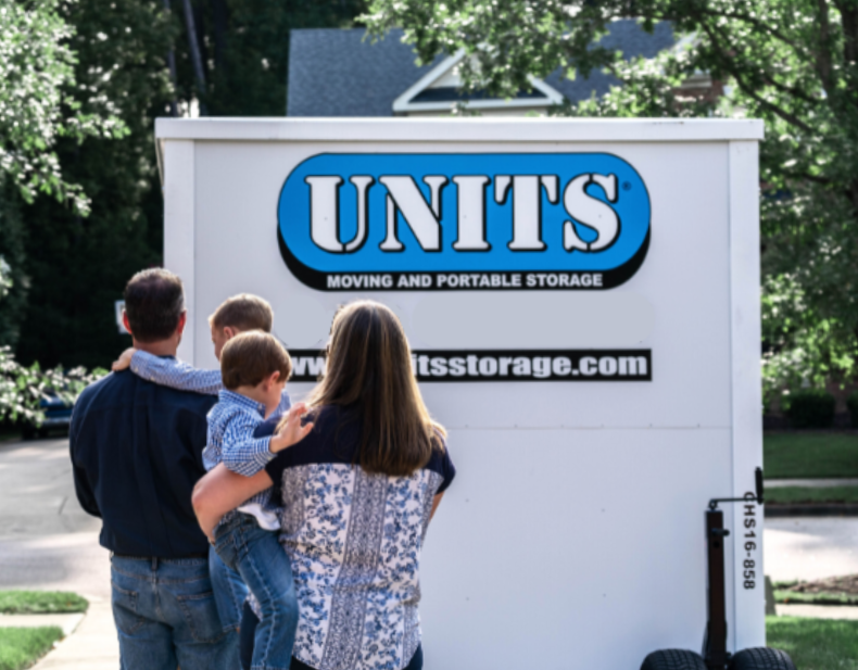 Family standing in front of a units container.