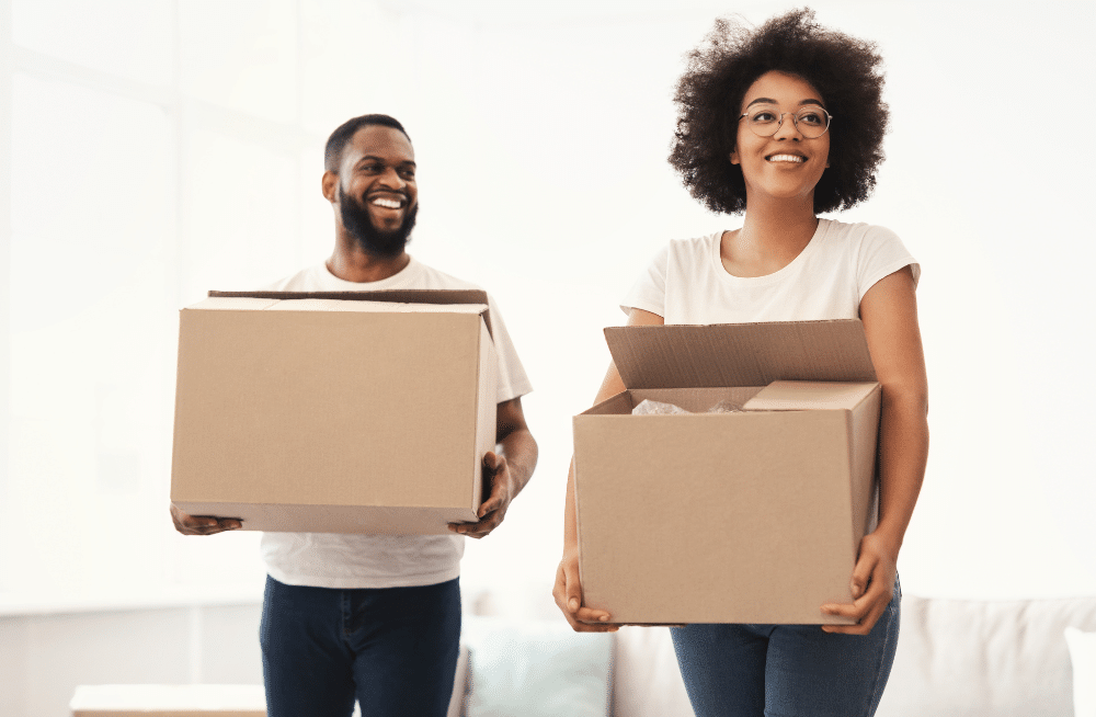 Couple carrying boxes.