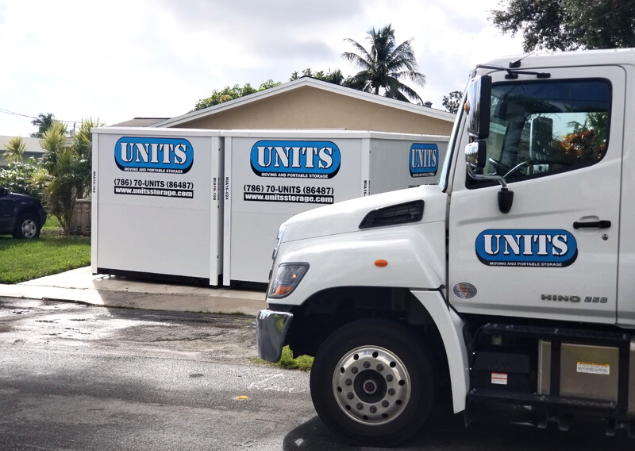 Two UNITS Moving and Portable Storage of Miami containers sitting in a driveway with a UNITS truck parked in the street.