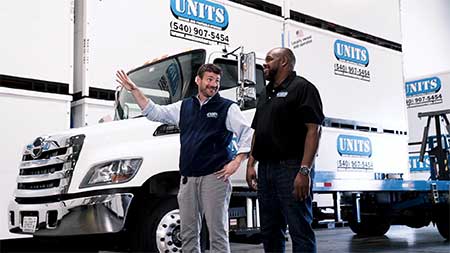 UNITS Moving and Portable Storage workers standing in front of a UNITS truck.