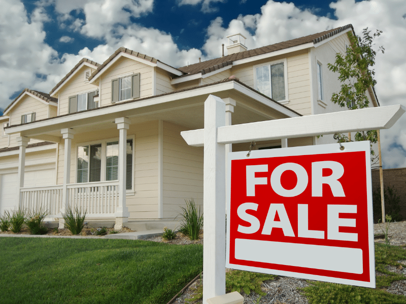 For sale sign in the front yard.