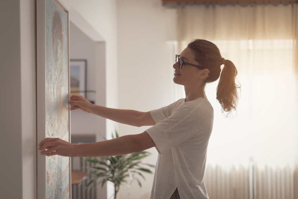 Units of Minneapolis woman hanging a painting