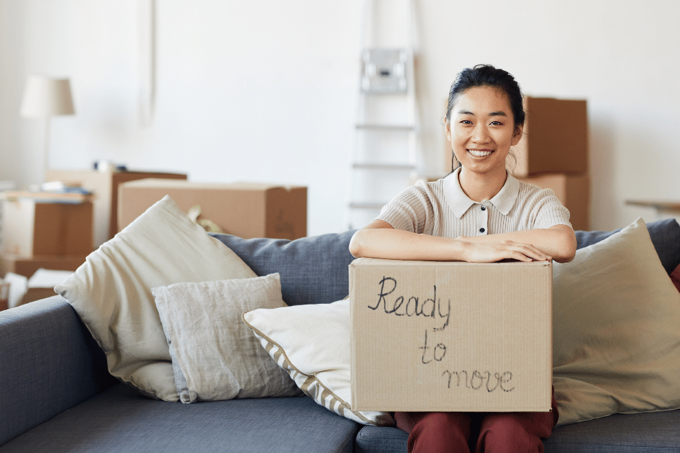 Units of Minneapolis woman sitting with a box that says 