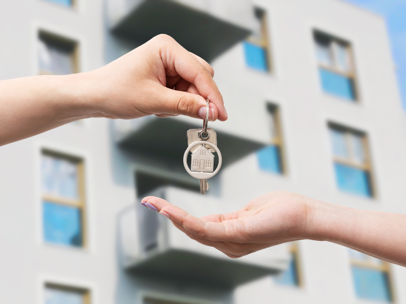 handing keys to person Renting an Apartment