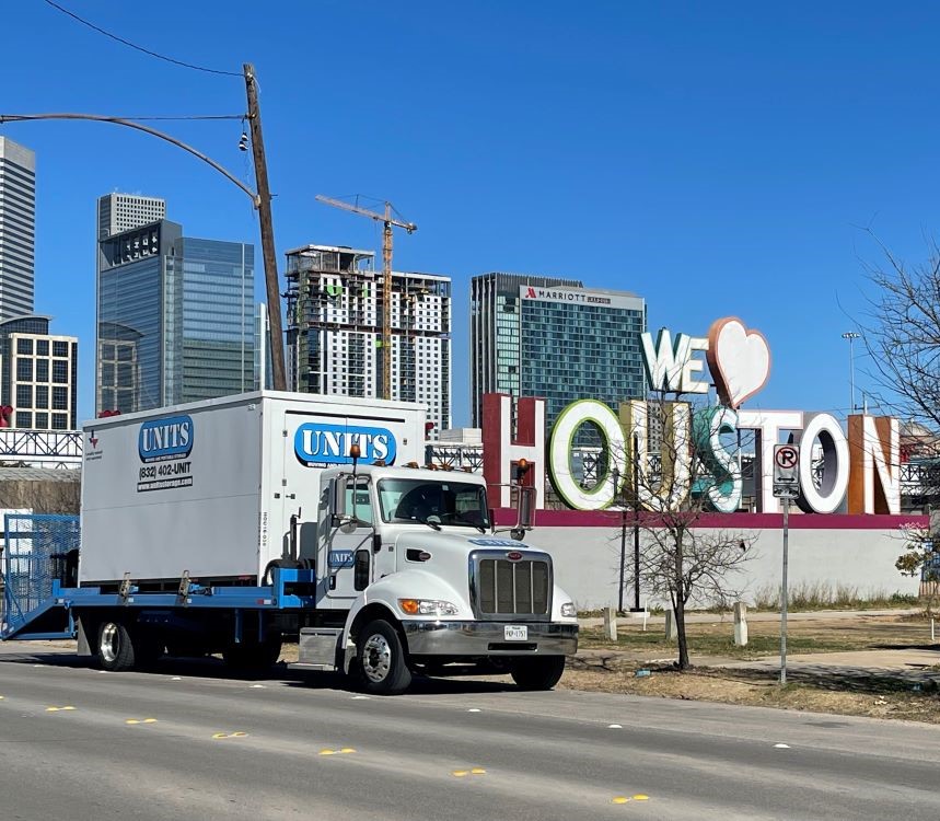 Units of North Houston units truck sitting in front of Houston sign