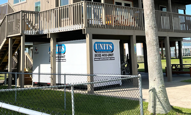 Units of North Houston container sitting under porch of house