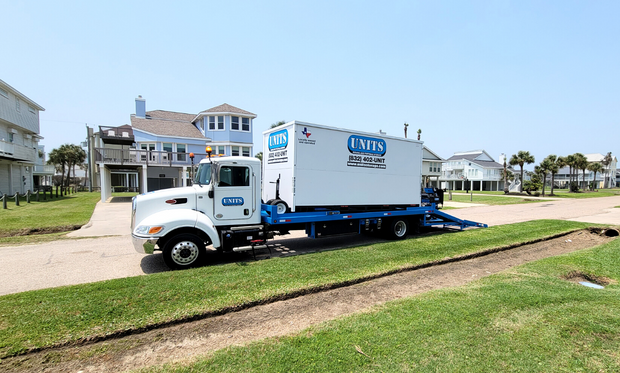 Units of North Houston container parked in front of house