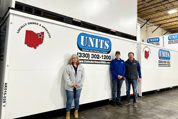 Units Of Northeast Ohio drivers standing in front of a container.