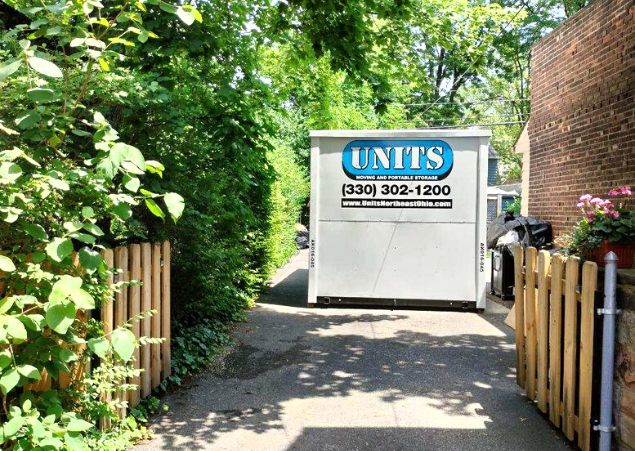 A Units Of Northeast Ohio container sitting in a driveway.