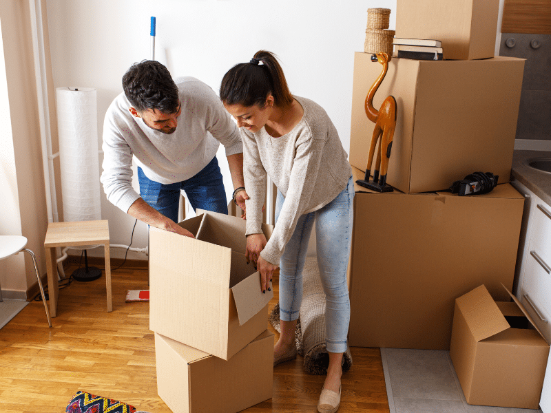 A couple unpacking boxes in their new home.