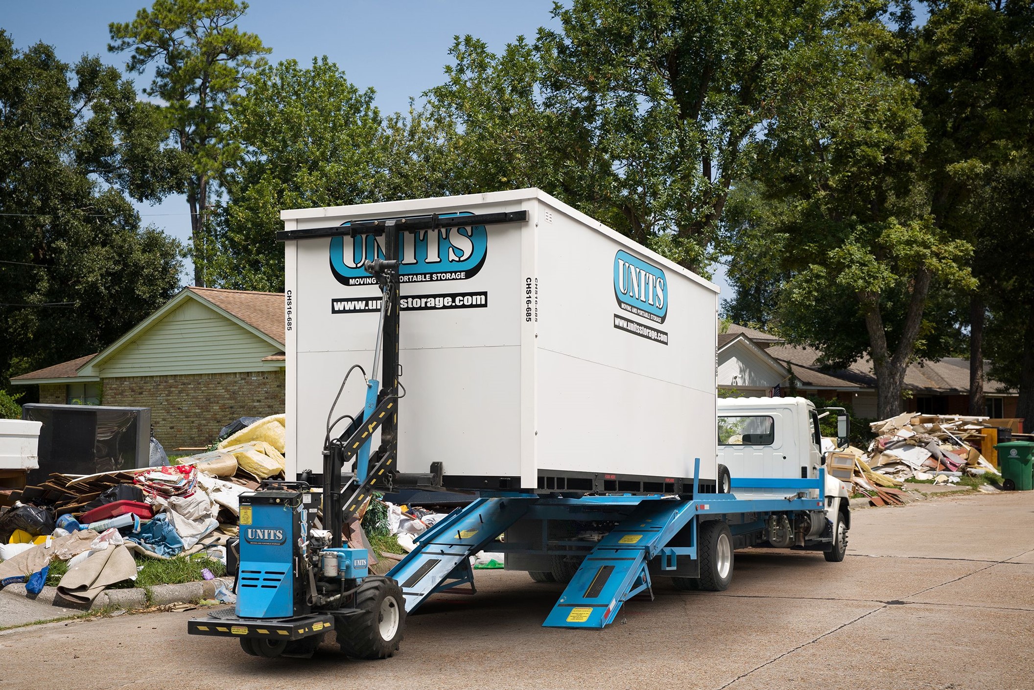 Units of Northwest Dallas Fort Worth container sitting in road after storm