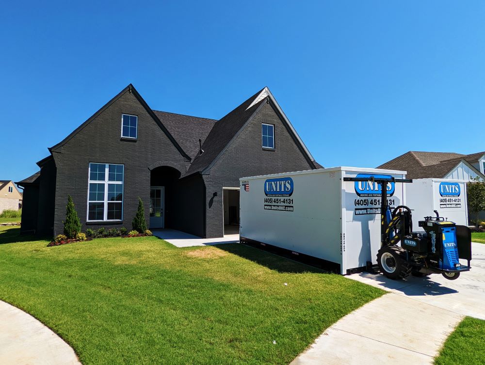 Two Units of Oklahoma City containers sitting in the driveway of a house.