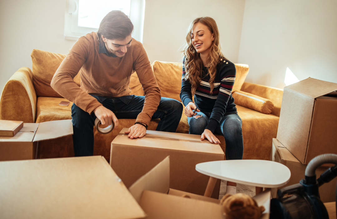 A family packing boxes in a living room.