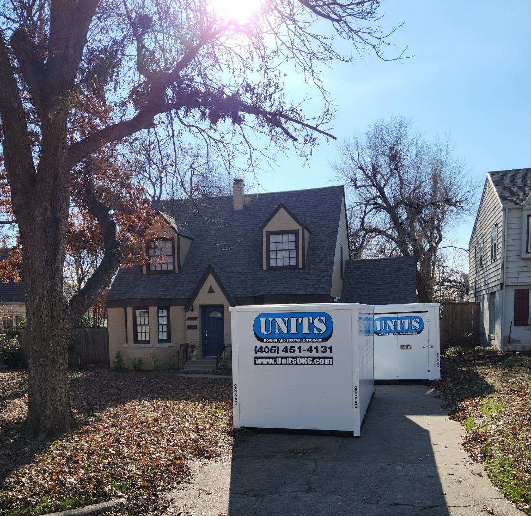 Two Units of Oklahoma City containers sitting in the driveway of a house.