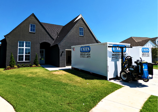 Two Units of Oklahoma City containers sitting in the driveway of a house.