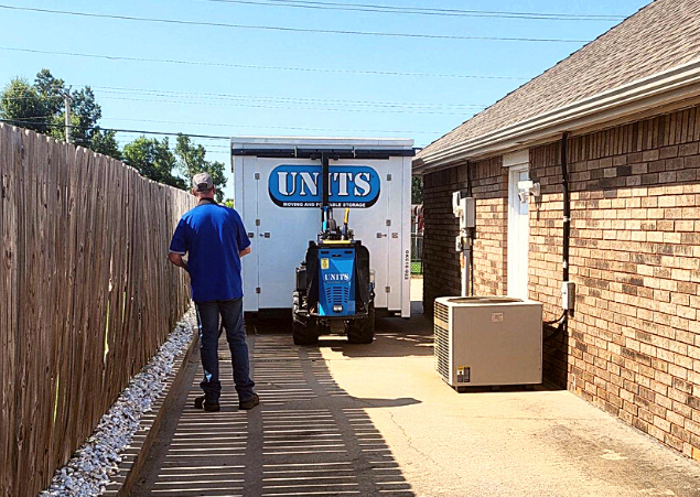 A Units of Oklahoma City container sitting in a driveway.