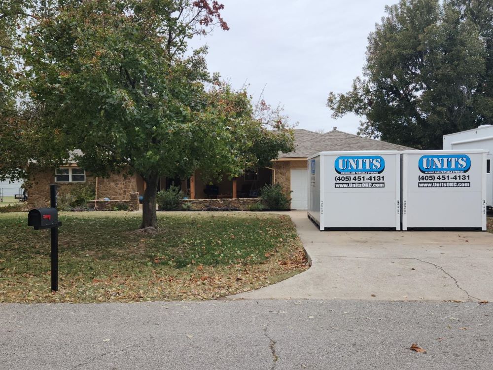 Two portable storage containers in front of a house after Postponing Your Move-In Date